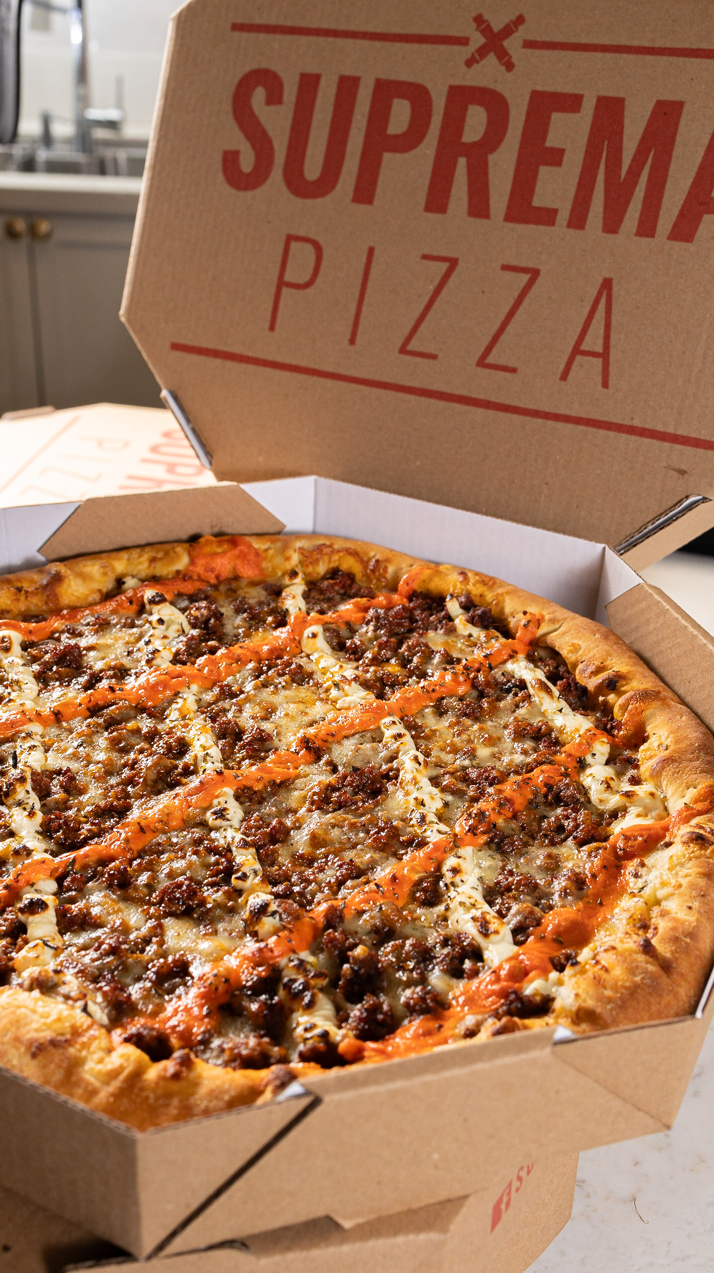 Pizza da Suprema na caixa de delivery